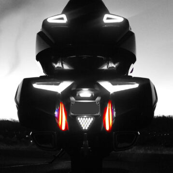 Image is the rear of the Honda Goldwing 2018+ in black and white showing the Fender Fill Lights in red.